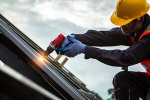 A homeowner compares a new asphalt shingle sample with weathered shingles on a residential roof.