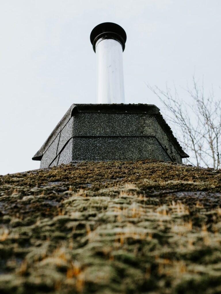 Uneven shingles and exposed flashing visible on a residential roof during a close inspection.